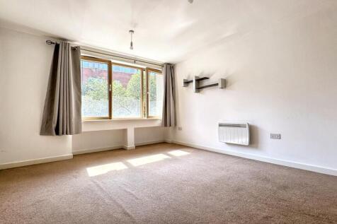 A bright and inviting living room featuring lar...