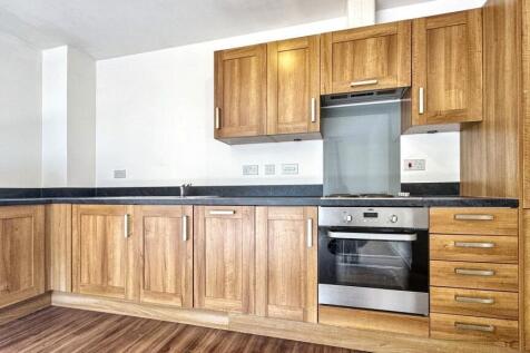 Modern kitchen featuring sleek wooden cabinetry...