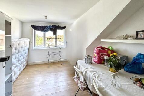 A cozy double bedroom featuring large windows t...