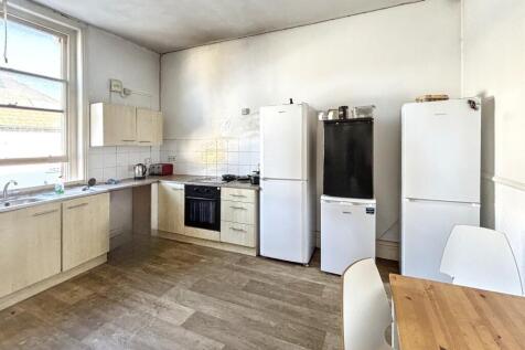 Spacious kitchen featuring modern appliances an...