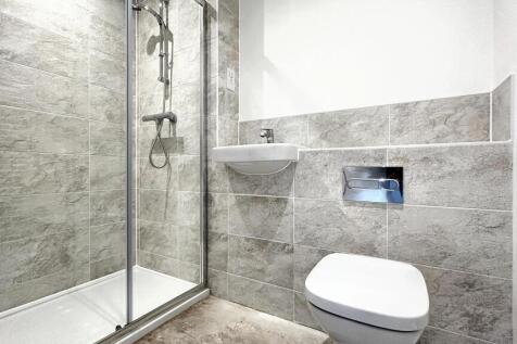 This modern bathroom features a sleek shower, s...