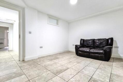 A spacious living room featuring a cozy leather...