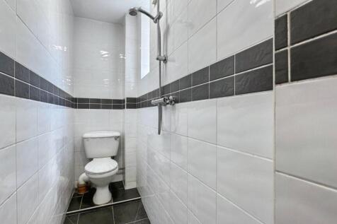 A stylish bathroom featuring modern tiles, a sh...
