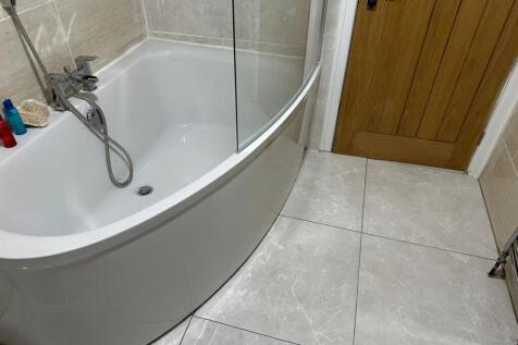This stylish bathroom features a sleek, modern ...