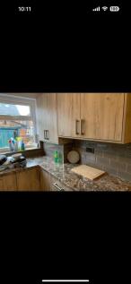 A modern kitchen featuring stylish wooden cabin...
