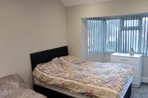 This cozy double bedroom features a comfortable...