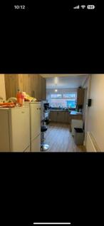 This spacious kitchen boasts modern appliances ...