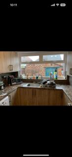 This cozy kitchen features modern wooden cabine...