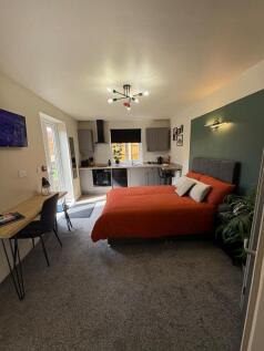 A stylish and spacious master bedroom featuring...