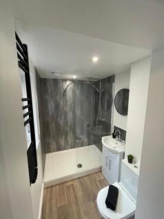 Modern bathroom featuring a spacious walk-in sh...