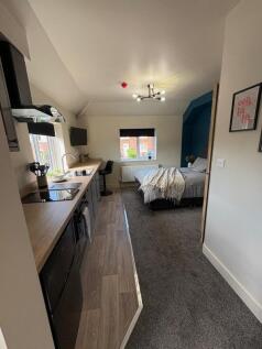 A modern and well-maintained studio bedroom fea...