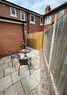 A neat and private garden area featuring a ston...
