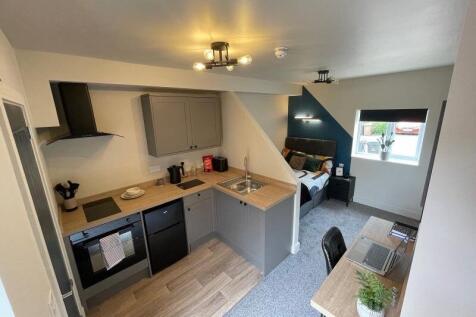 Bright and modern studio apartment featuring a ...
