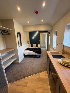 A modern, well-lit single bedroom featuring a c...