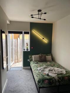 A bright and inviting single bedroom featuring ...