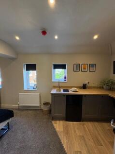 A modern, compact studio space featuring a neat...