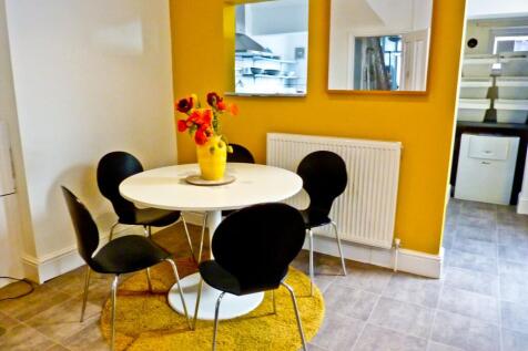 A stylish kitchen area featuring a round dining...