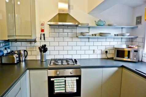 This modern kitchen features sleek cabinetry, a...