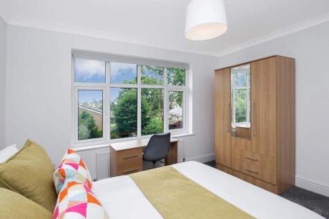 This inviting double bedroom features large win...