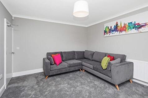 This inviting living room features a comfortabl...