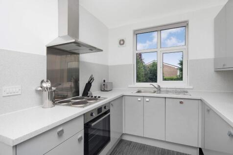 Modern kitchen with sleek cabinetry and ample n...