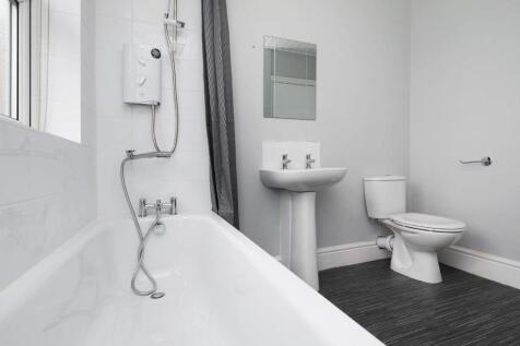 This modern bathroom features a spacious layout...