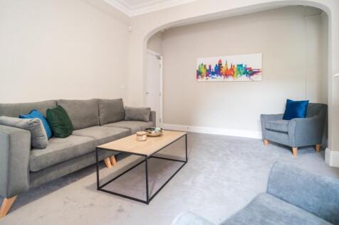 Spacious and inviting living room featuring con...