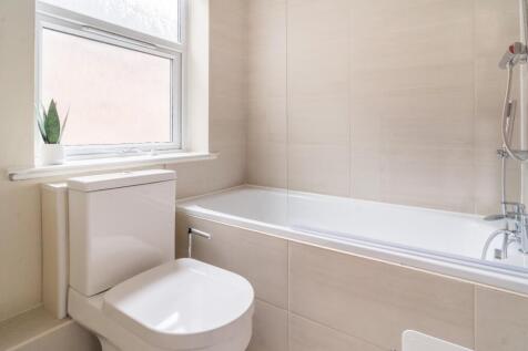 This modern bathroom features a sleek bathtub a...