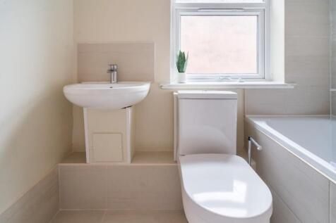 A modern bathroom featuring sleek fixtures, a s...