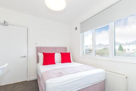 Bright and inviting double bedroom featuring la...