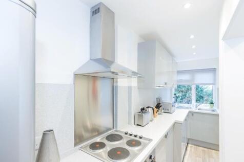 This modern kitchen features sleek cabinetry an...