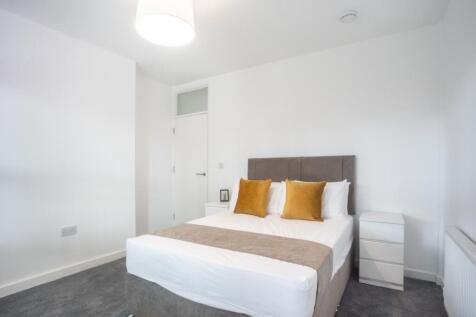 This inviting double bedroom features a stylish...
