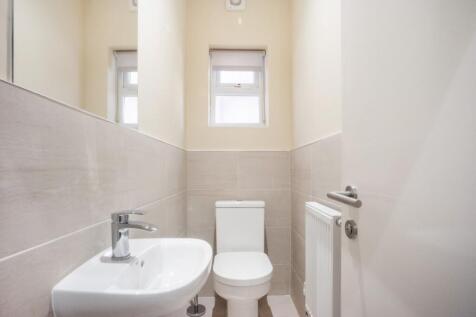 A modern and tidy single toilet featuring sleek...