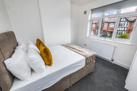 Bright and cozy double bedroom featuring a comf...