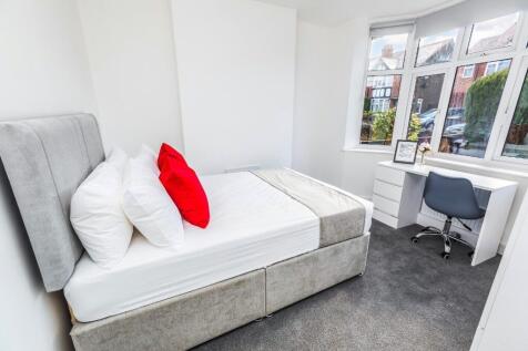 This stylish double bedroom features a comforta...