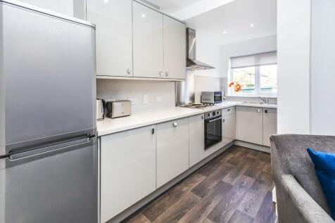 This modern kitchen features sleek cabinetry an...