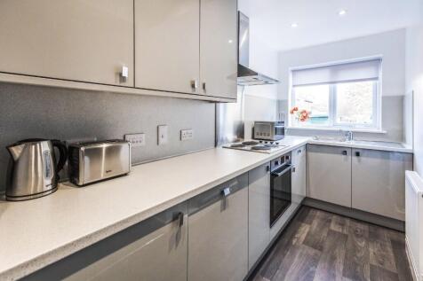 This modern kitchen features sleek cabinetry an...