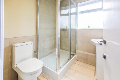 This modern bathroom features a sleek shower en...