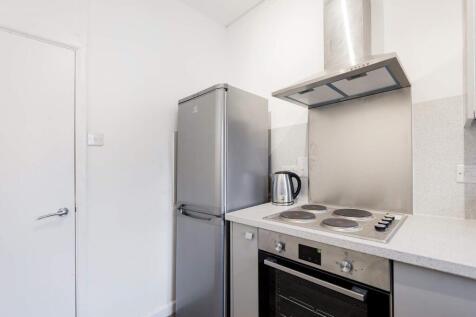 This modern kitchen features sleek appliances, ...