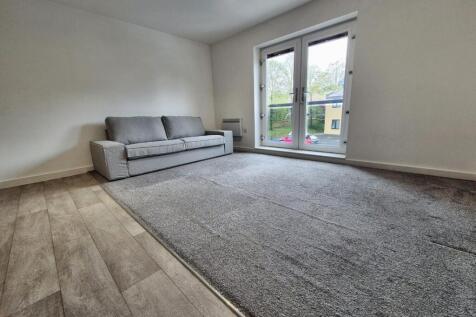 This contemporary living room features a spacio...