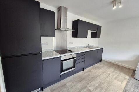 Modern kitchen featuring sleek black cabinetry ...