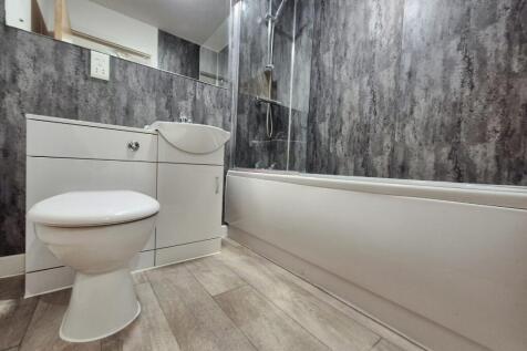 A modern bathroom featuring a sleek design with...