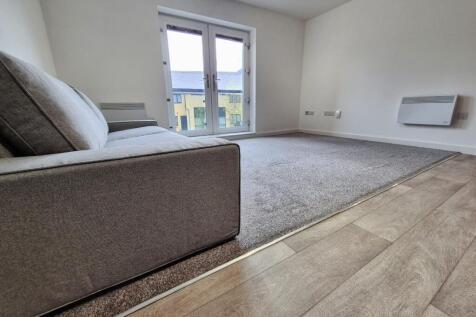 This inviting living room features ample natura...