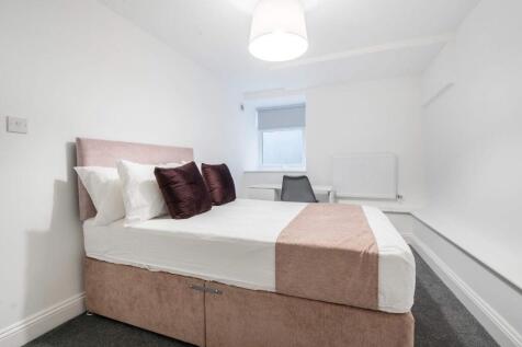 This inviting double bedroom features a comfort...