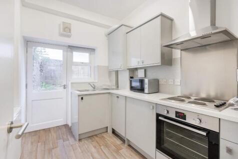 Modern kitchen featuring sleek cabinetry, ample...