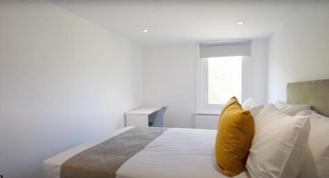 A bright and inviting double bedroom featuring ...