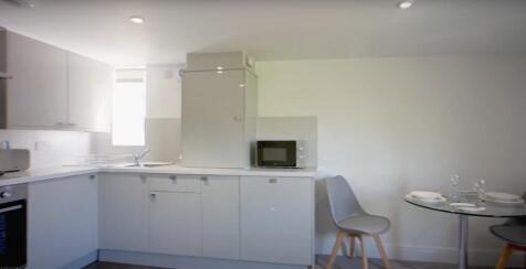 Well-equipped kitchen featuring modern applianc...