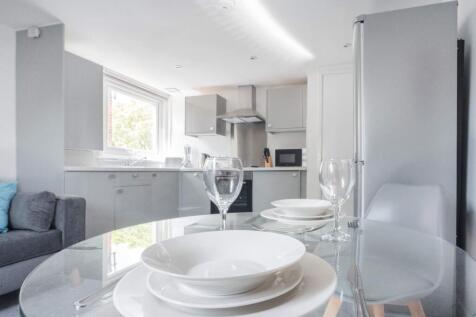 This modern kitchen combines sleek design with ...