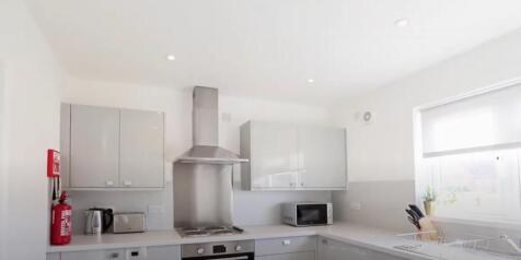 Modern kitchen featuring sleek cabinetry and am...