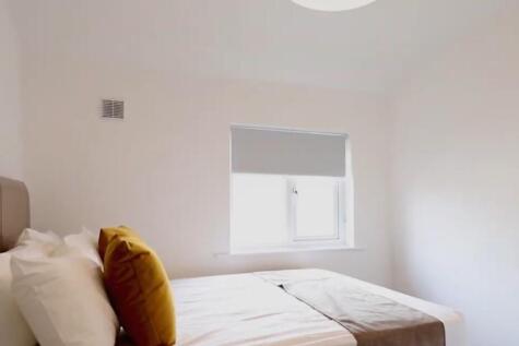 This inviting double bedroom features a cozy de...